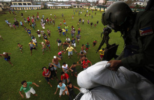 A Philippine Air Force crew drops sacks containing food supplies to Typhoon Haiyan survivors in Tunga
