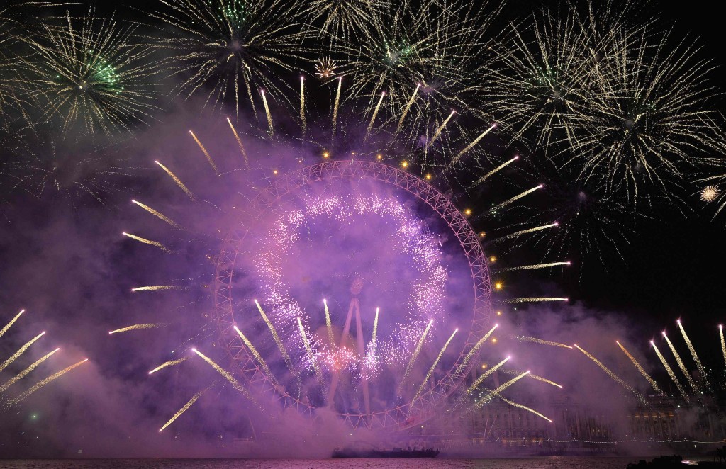 Fireworks explode around the London Eye wheel during New Year celebrations in central London