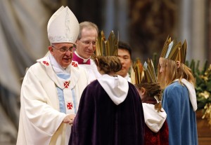 Children bring Pope Francis a chalice during the offertory as he leads a mass at Saint Peter's Basilica at the Vatican