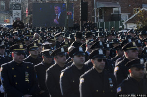 Police officers turn their backs as New York City Mayor Bill de Blasio speaks at the funeral of New York city police officer Rafael Ramos in Queens on Saturday. (AP Photo/John Minchillo)
