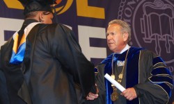 Monroe College Graduation -- President Stephen Jerome confers a degree  to a graduating student.
