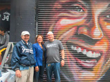 (l-r) Dr. Cary Goodman, 161st Street BID’s executive director; Council Speaker Mark-Viverito; and Mike Rendino, Stan’s Sports Bar owner, in front of the Derek Jeter mural. Photo courtesy 161st St BID