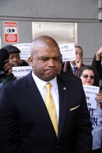 A grim-faced Keith Walton is joined by supporters outside of the Bronx Hall of Justice. Photo by David Greene