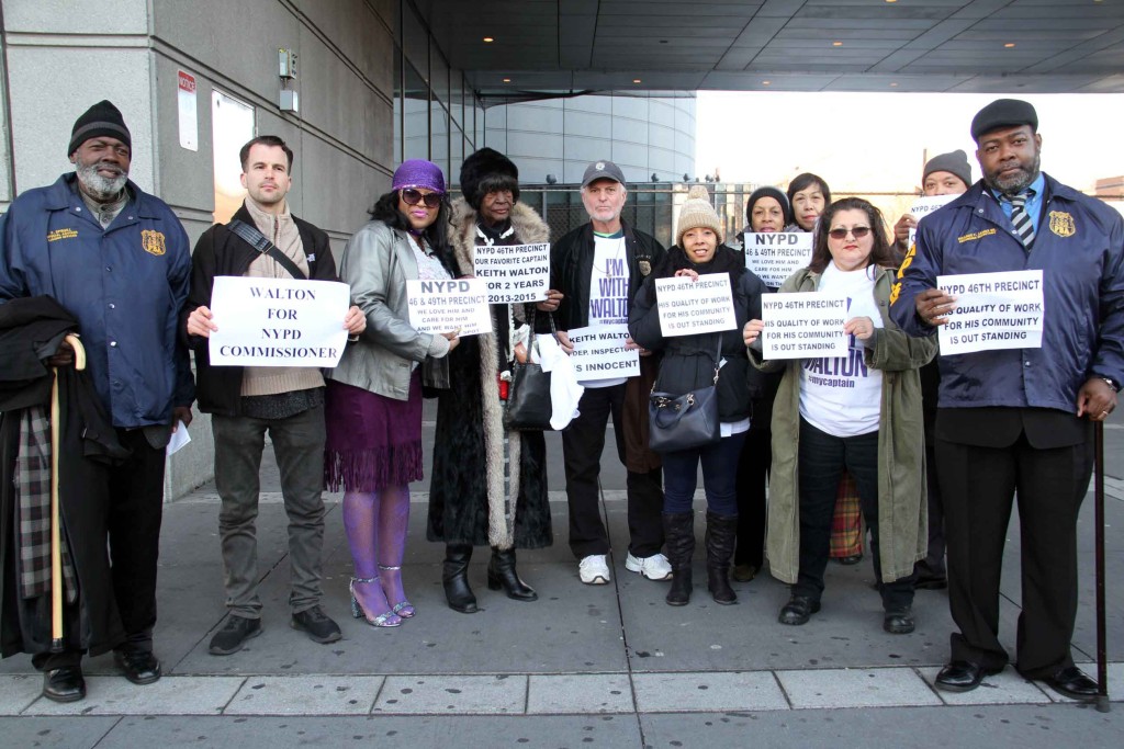 Supporters hold signs in support of Deputy Inspector Keith Walton who faces sex abuse charges. Photo by David Greene.
