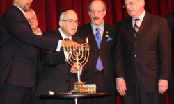 December 22, 2016: Borough President Ruben Diaz Jr. (far L) is assisted by Rabbi Israel Greenberg (middle L), U.S. Congressman Eliot Engel, & NYS Assemblymember Jeffrey Dinowitz in lighting the menorah