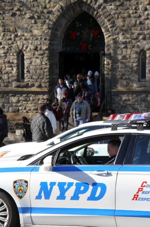 Members of the NYPD stationed outside St. Phillip Neri Church after ISIS published the address of thousands of U.S. churches. Photo by David Greene