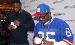 Former NY Giants (l-r): Justin Tuck and Stephen Baker sign autographs for fans during a Super Bowl viewing party at Empire City Casino on Yonkers, N.Y. Photo courtesy of Empire City Casino