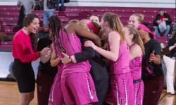 Fordham Lady Rams Coach Gaitley celebrates record win with players. Phot credit: Robert Cole.