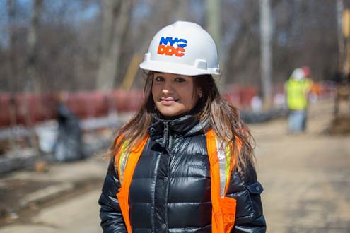 Borough resident and DDC Resident Engineer, Ketty Paulino, inspects construction along Bainbridge Avenue in the Bronx