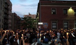 The large crowd holds candles outside of the 46th Precinct.--Photo by David Greene