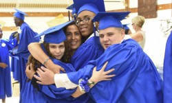 Proud New York Institute for Special Education (NYISE) graduates celebrate with a group hug following the 2017 graduation ceremony for the school’s Schermerhorn and Van Cleve programs on June 21. (Photo Credit: James Rivera)