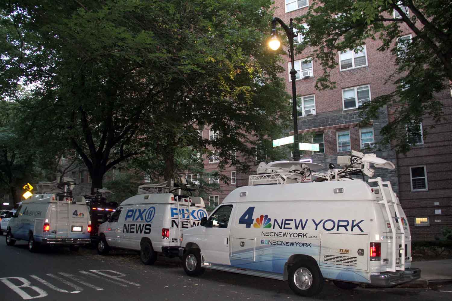 Members of several local television news networks were camped outside of the Amalgamated Houses where police say two young children were murdered.--Photo by David Greene
