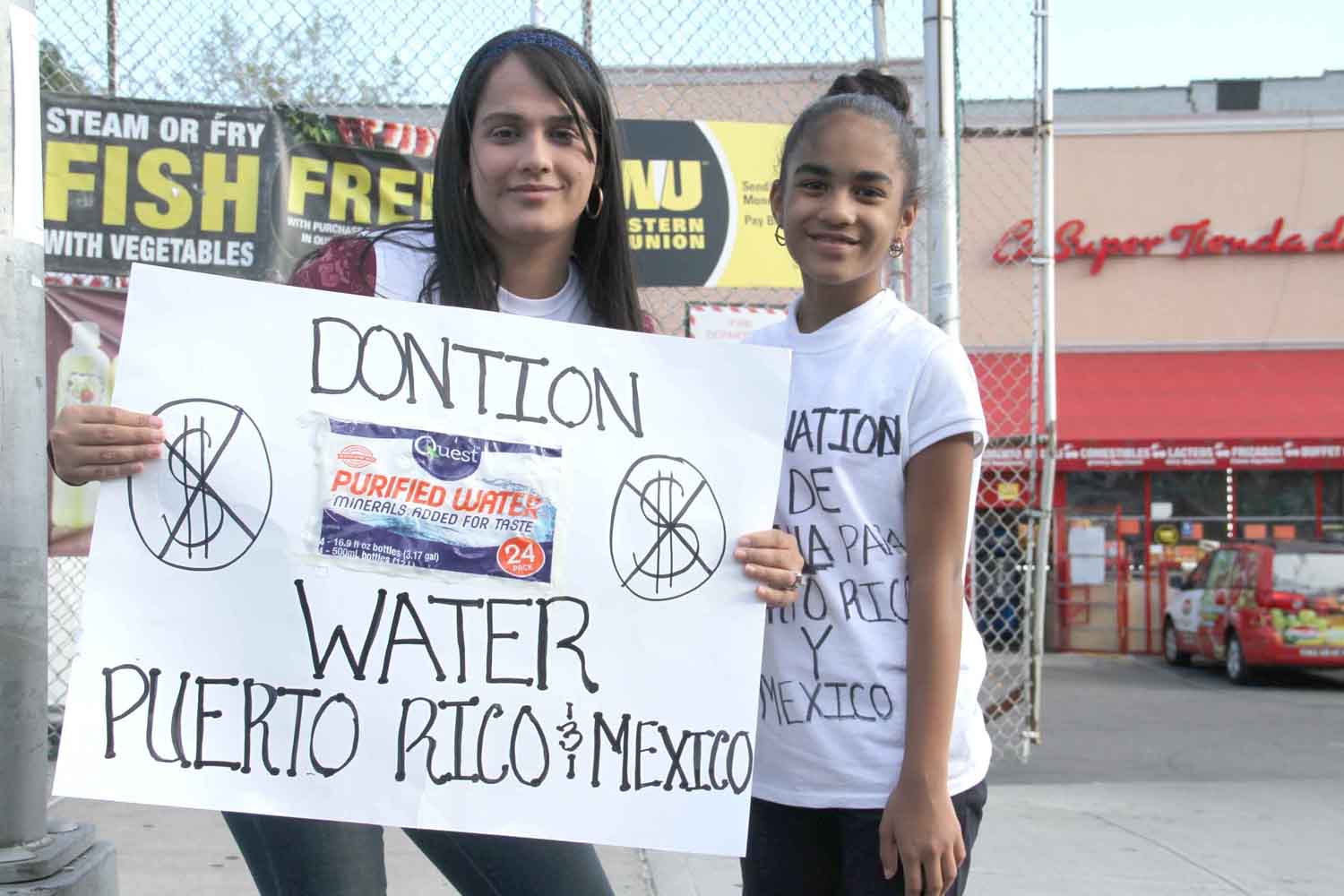 A mother and daughter in Bedford Park seek food and water donations along Webster Avenue for hurricane victims in Puerto Rico and earth quake victims in Mexico.--Photo by David Greene