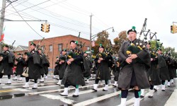 Members of the NYPD Emerald Society march in sync during the Morris Park Columbus Day parade.--Photo by David Greene