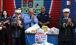 FDNY brass stand with donated items headed for Puerto Rico.--Photo by David Greene