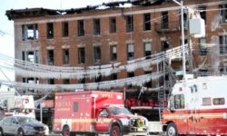 Firefighters look over the 4-story building that burned for more than eight-hours on January 2.--Photo by David Greene