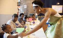 Black Panther gives the “high five” of approval to the kids who completed their bookmaking session